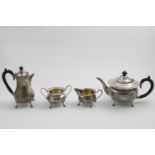 AN EARLY 20TH CENTURY FOUR-PIECE TEA SERVICE with circular bodies, shaped rims, and four feet, by