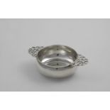 A LATE VICTORIAN SCOTTISH NUT DISH plain squat circular form with two pierced handles, initialled "