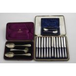 A CASED SILVERGILT FRUIT SERVING SET to include two later-decorated or "berry" table spoons and a