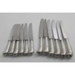 A SET OF SIX GEORGE II TABLE KNIVES AND FIVE SIDE KNIVES with leaf-capped pistol handles, crested,