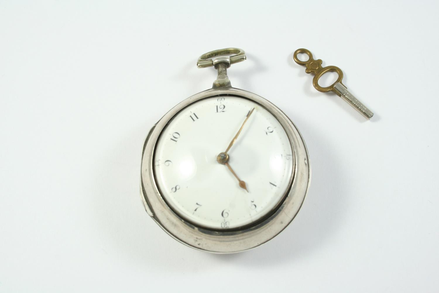 A SILVER PAIR CASE VERGE POCKET WATCH the white enamel dial with Arabic numerals, the movement