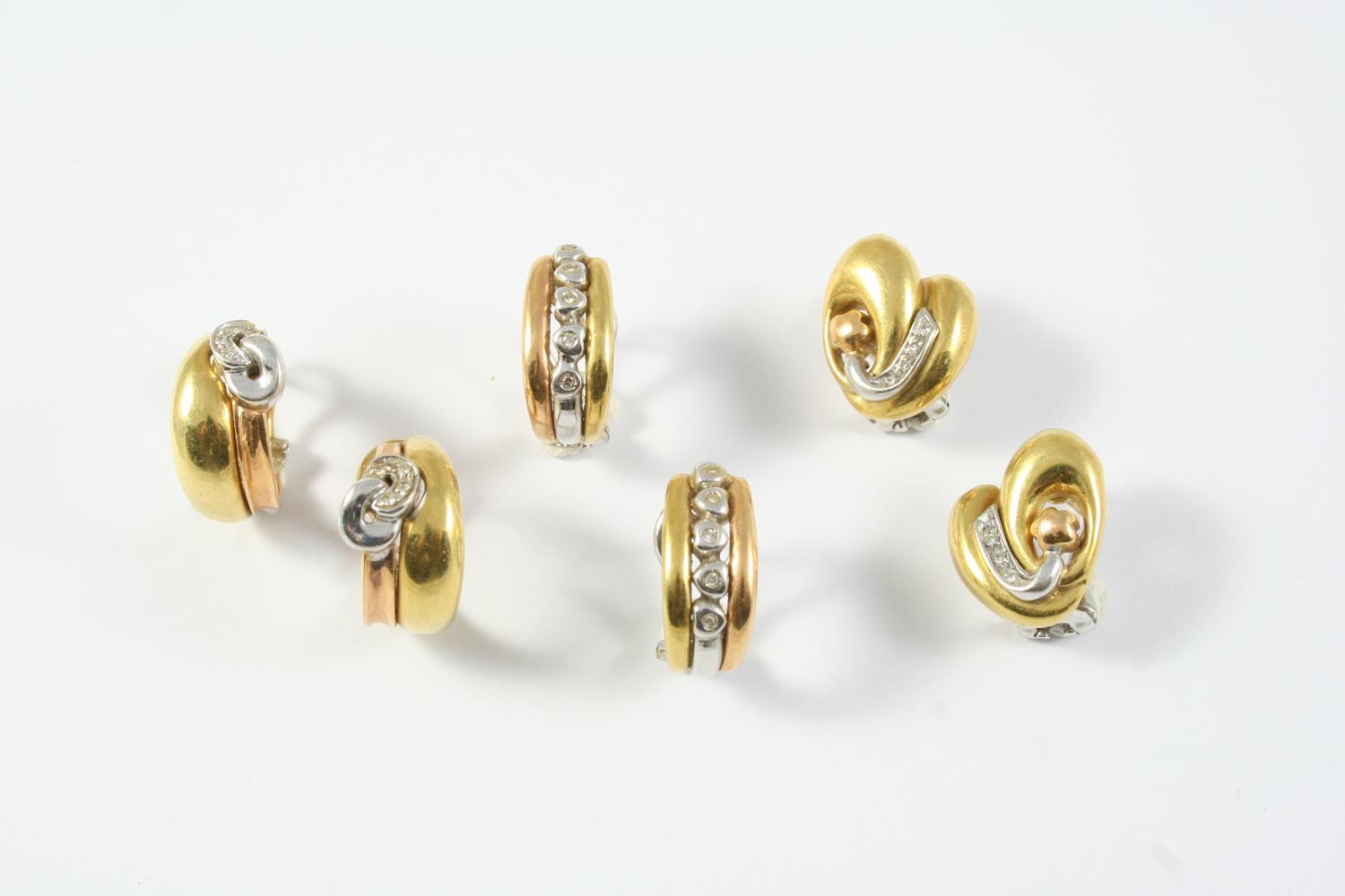 A PAIR OF DIAMOND AND 18CT GOLD HALF HOOP EARRINGS each earring set with a row of five collet