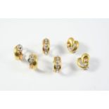 A PAIR OF DIAMOND AND 18CT GOLD HALF HOOP EARRINGS each earring set with a row of five collet