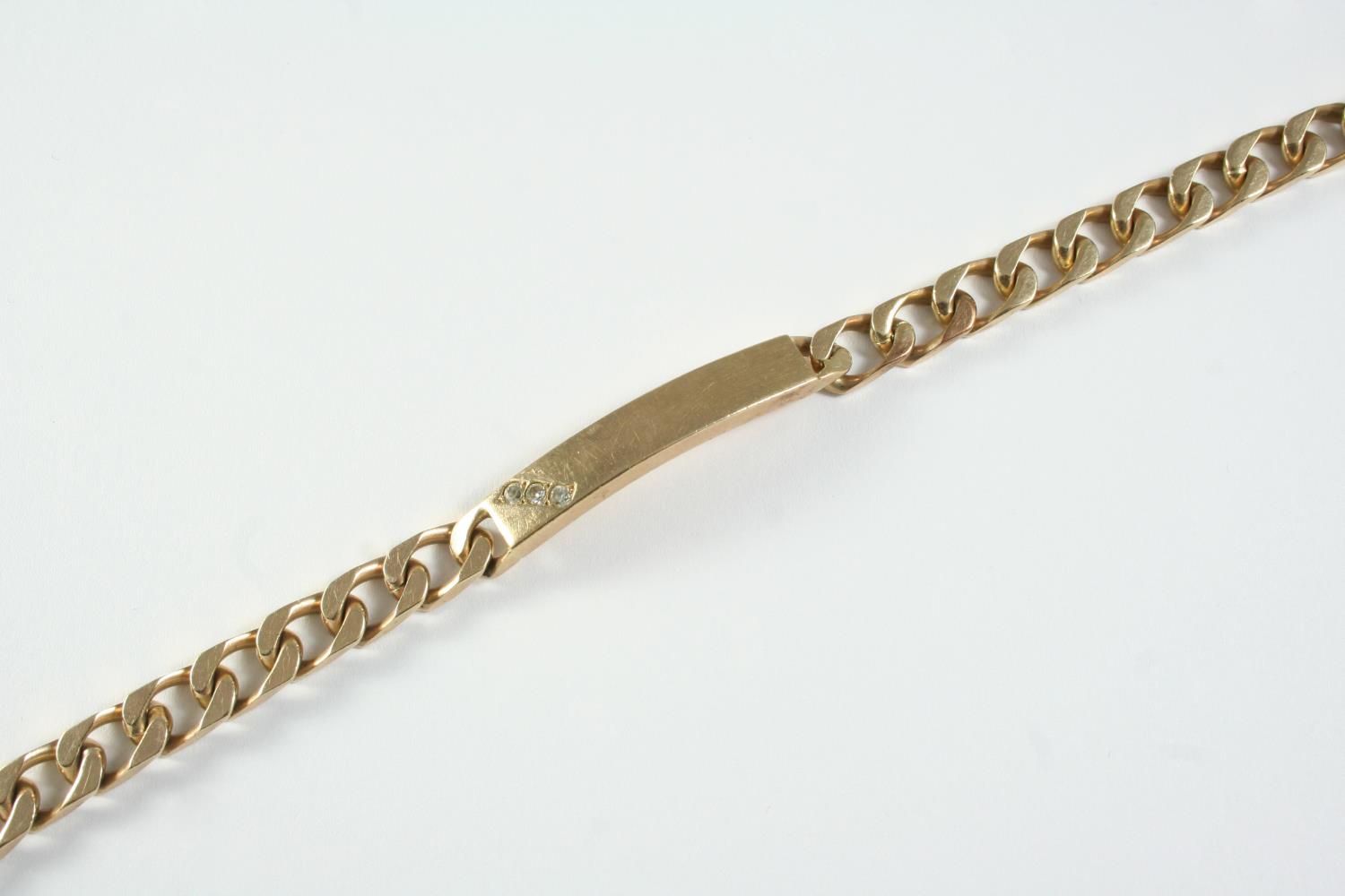 A 9CT GOLD IDENTITY BRACELET mounted with three white stones, 19.5cm long, 32.1 grams