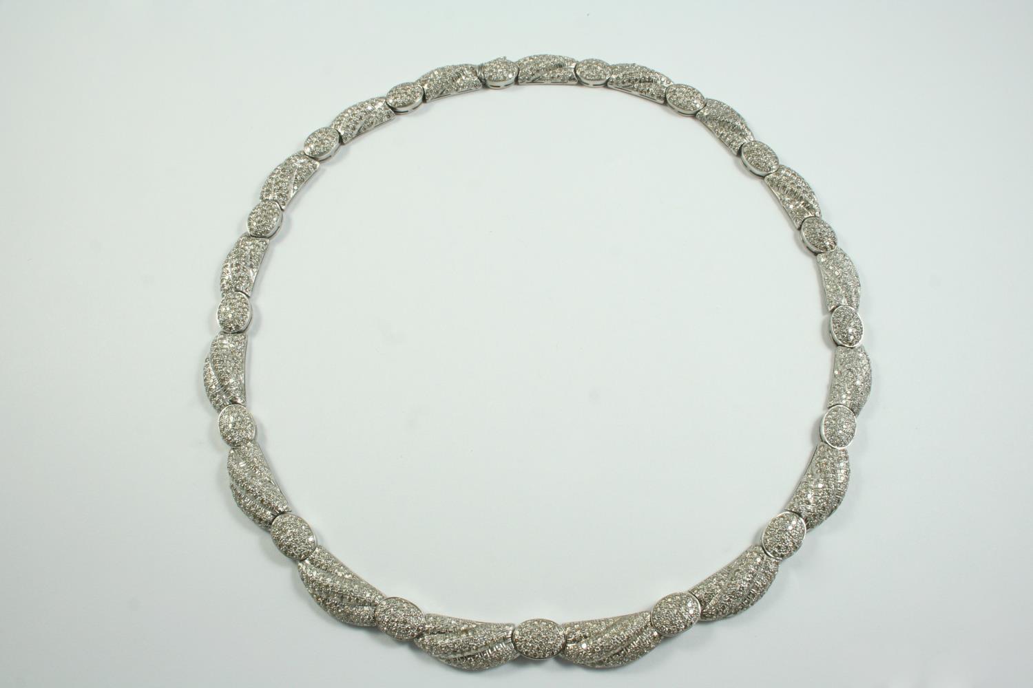 A DIAMOND COLLAR NECKLACE set overall with circular-cut diamonds, in 18ct white gold, long
