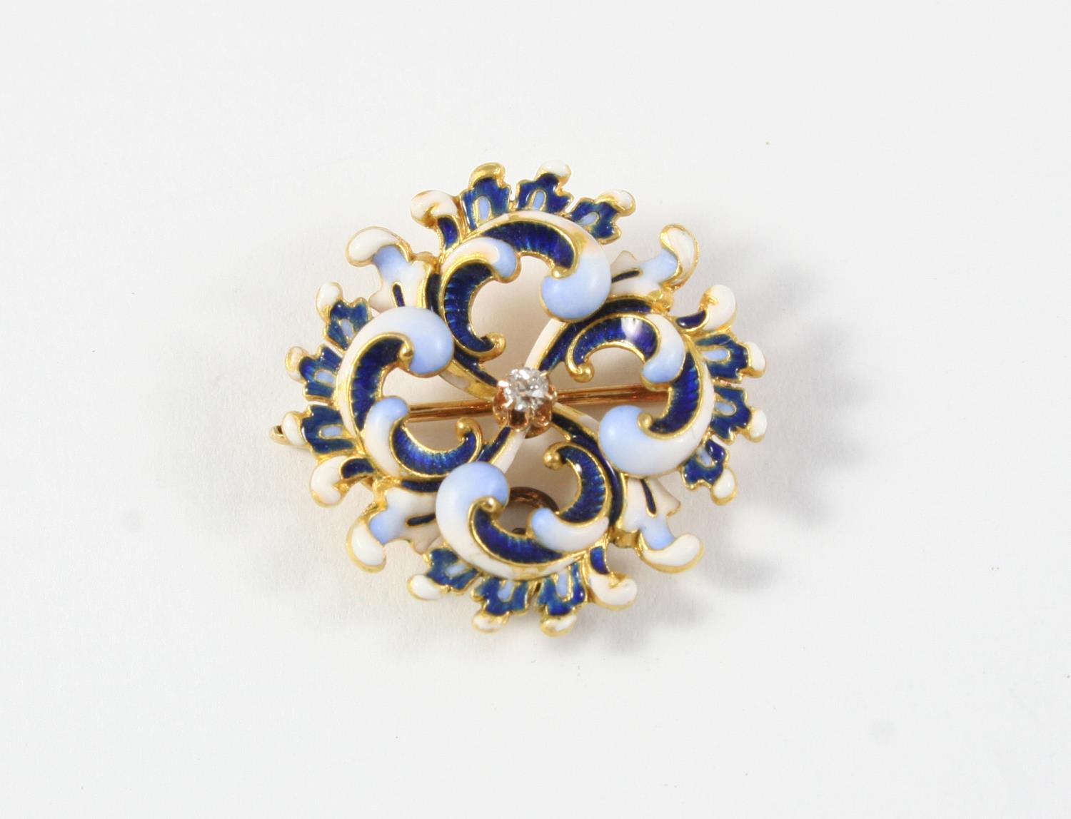 AN ENAMEL AND DIAMOND BROOCH PENDANT centred with a circular-cut diamond within a swirling