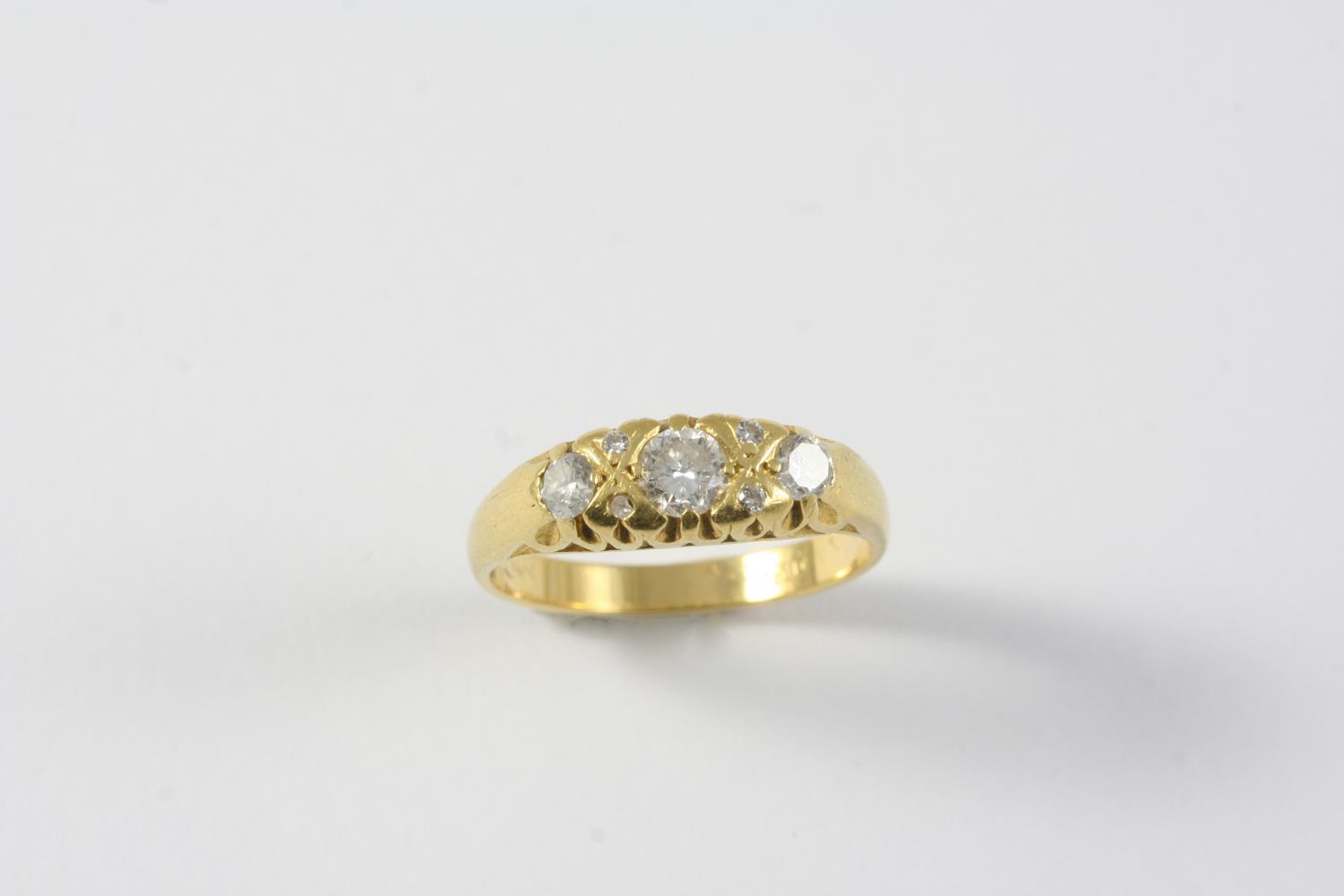A DIAMOND THREE STONE RING the three graduated circular-cut diamonds are set with circular diamond