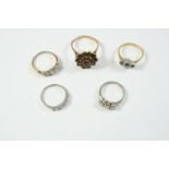 FIVE ASSORTED GOLD AND GEM SET RINGS including a diamond three stone ring, set in white gold and