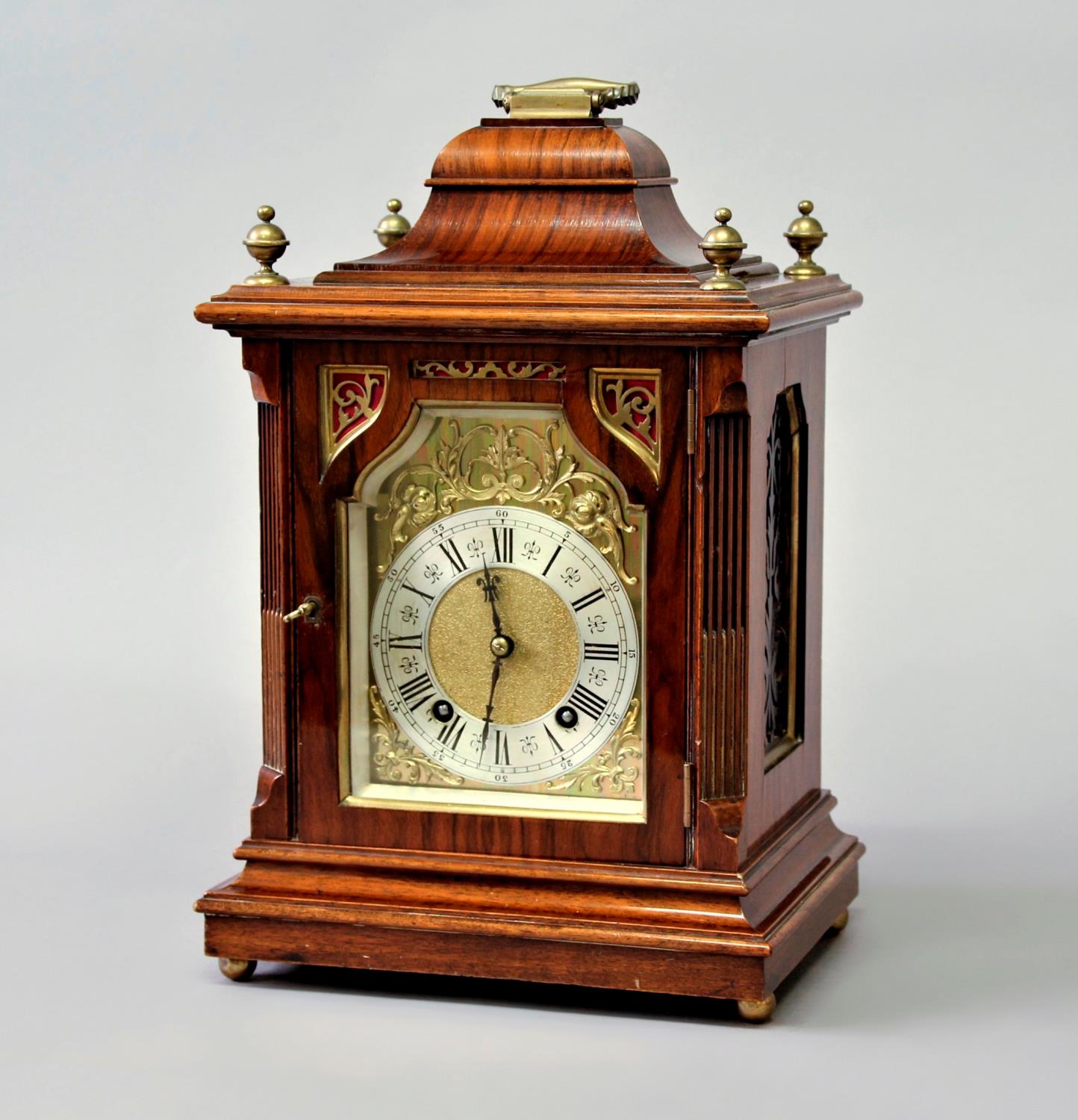 A WALNUT AND BRASS MOUNTED MANTEL CLOCK, late 19th century, the brass dial with a 4 1/2" silvered