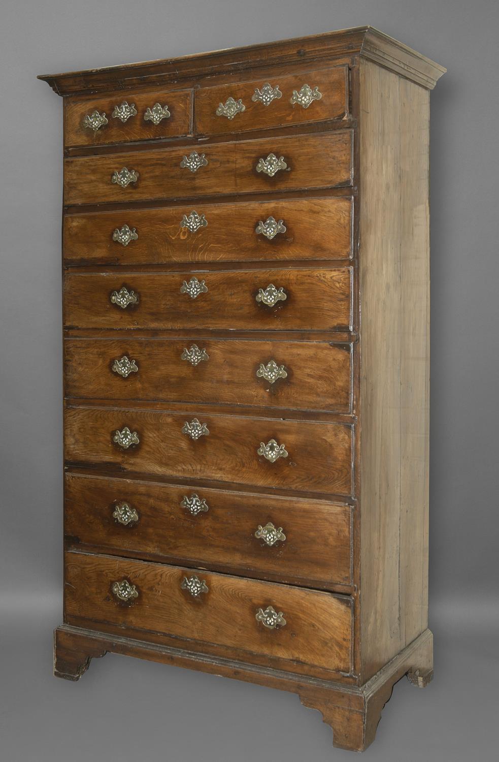 A GEORGE III OAK TALL CHEST OF DRAWERS. The chest with two short and seven long graduated drawers