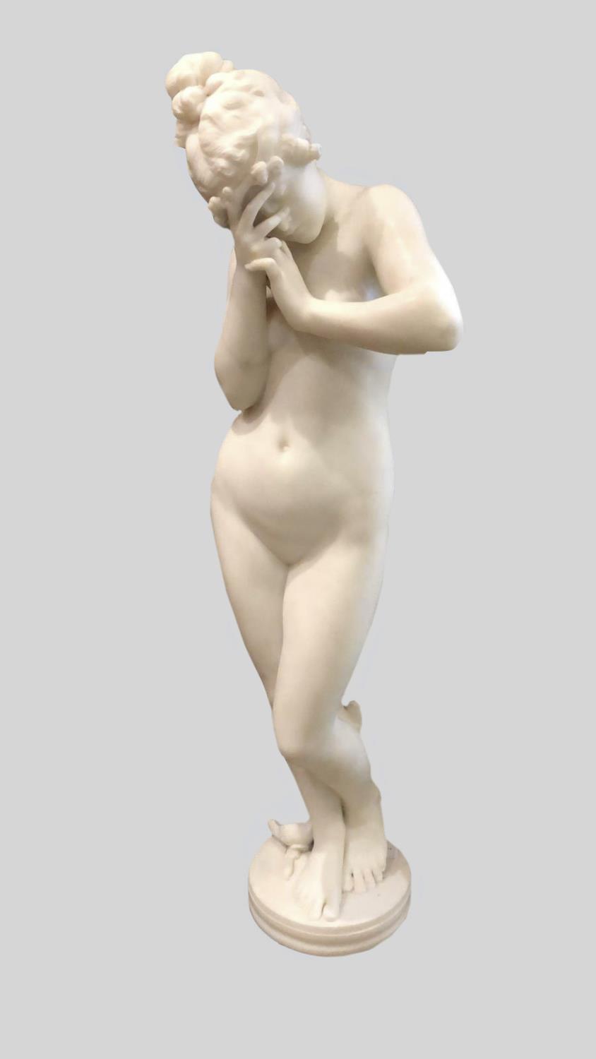 A VICTORIAN MARBLE STATUE OF A NAKED WOMAN. The white marble figure shyly covering her face with her