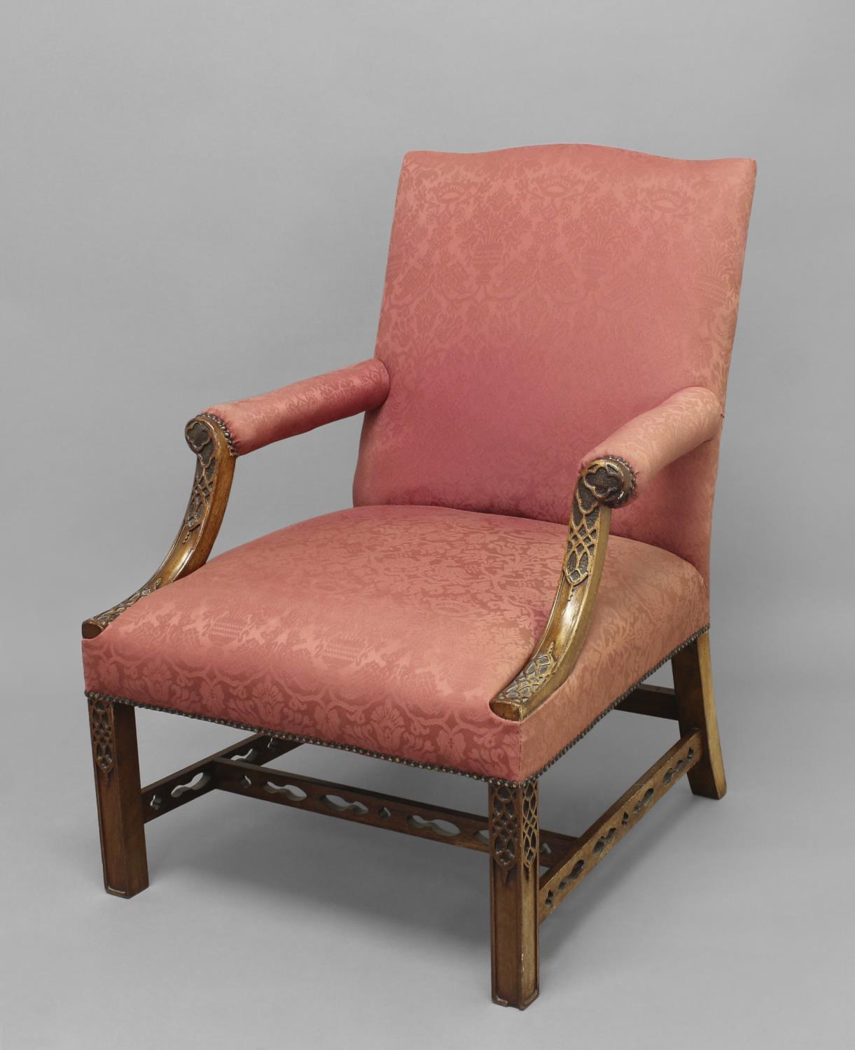 A GAINSBOROUGH STYLE ELBOW CHAIR, the rectangular back with slight wavy top above padded,
