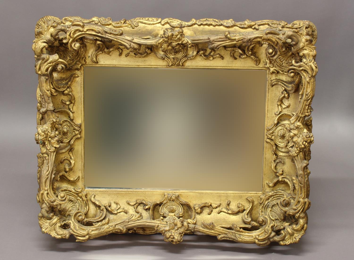 AN ELABORATE LATE 19TH CENTURY STYLE WALL MIRROR. An elaborate rectangular wall mirror with a