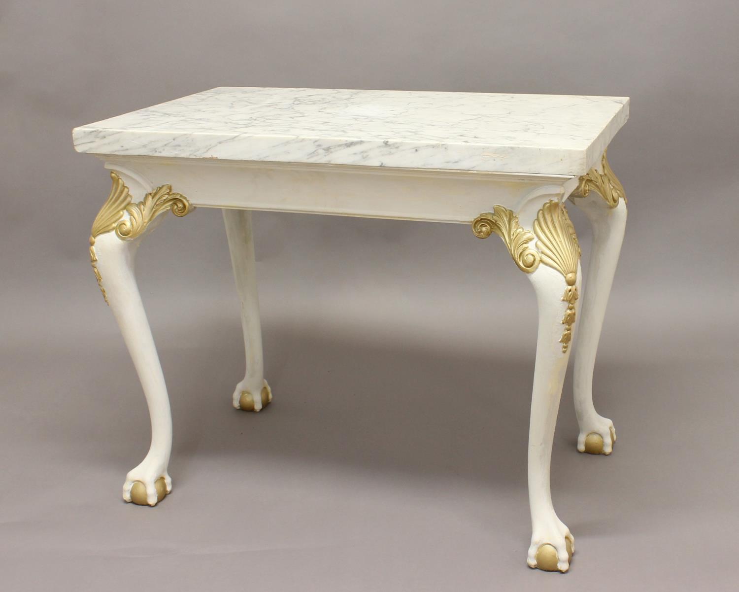 A MARBLE TOPPED CONSOLE TABLE, 20th century, the painted base with gilt detailing on ball and claw