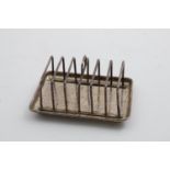 A VICTORIAN TOAST RACK with seven bars and a rectangular tray base with an engraved foliate