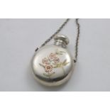 A LATE VICTORIAN CIRCULAR SCENT FLASK with suspensory chain and screw cover, decorated on one side