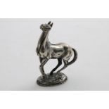 A LATE 20TH CENTURY CAST SCULPTED FIGURE OF A STALLION on an oval base, about to rear up, signed "