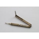 AN EDWARDIAN COMBINED PENCIL, FOLDING RULE (calibrated to 6 inches) and penknife with a steel blade,