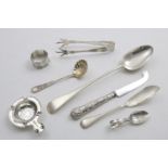 A MIXED LOT:- A George V basting spoon, a Victorian Bead pattern butter knife, a Victorian