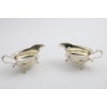 A PAIR OF GEORGE VI SAUCE BOATS with shaped rims & three legs, by Elkington & Co., Birmingham