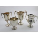 FOUR VARIOUS TWO-HANDLED TROPHY CUPS each with a presentation inscription, (three relating to the