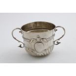 A WILLIAM III PORRINGER with emobssed part-fluting, a chased cartouche with scrolls, matting and