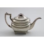 A GEORGE III NORTH COUNTRY PROVINCIAL TEA POT of rounded oblong form with reeded borders and ball