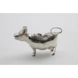 AN ELIZABETH II COW CREAMER with textured hair on her head and along her back, with a looping tail