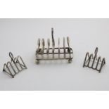 A GEORGE V TOAST RACK on ball feet with seven arched bars, by Martin Hall & Co., Sheffield 1914