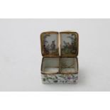 A CONTINENTAL PORCELAIN SNUFF BOX two compartments with hinged covers, the body painted with flowers