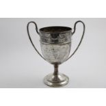 A GEORGE V TWO-HANDLED TROPHY CUP with embossed drapery swags below the rim, inscribed "Taunton