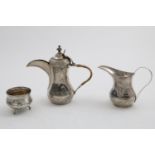 AN EARLY 20TH CENTURY IRAQI SMALL NIELLO-WORK COFFEE POT, A MILK JUG & A SUGAR BOWL on three legs;