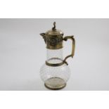 A VICTORIAN SILVERGILT MOUNTED CLEAR GLASS CLARET JUG with a star-cut base and a pattern of