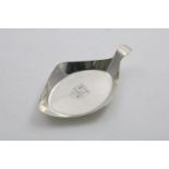 AN ELIZABETH II SMALL DISH with an upswept handle, engraved in the centre with the arms of the