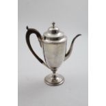 A GEORGE III NORTH COUNTRY PROVINCIAL COFFEE POT of vase form on a circular pedestal foot with