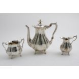 AN EARLY 20TH CENTURY SWEDISH THREE-PIECE COFFEE SET with fluted, baluster bodies and four feet,