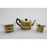 AN EDWARDIAN THREE-PIECE SILVERGILT BACHELORS' OR AFTERNOON TEA SET with rounded oblong bodies,