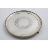 A GEORGE V CIRCULAR SALVER with a bead border and an engraved circular cartouche in the centre, by