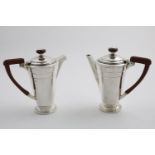 A PAIR OF GEORGE VI ART DECO REVIVAL CAFE AU LAIT POTS with tapering circular bodies, stepped