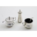 AN ELIZABETH II HANDMADE THREE-PIECE CONDIMENT SET with circular bodies, pierced bases and two