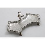 A GEORGE II WAISTED SNUFFERS TRAY with a shaped & moulded border, interspersed with shells, flat-