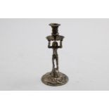 A GEORGE II CAST HARLEQUIN TAPERSTICK on a domed rocaille base, by John Cafe, London 1751; 5.4" (