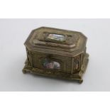 A 19TH CENTURY CONTINENTAL SILVERGILT CASKET of canted rectangular form with ball feet and