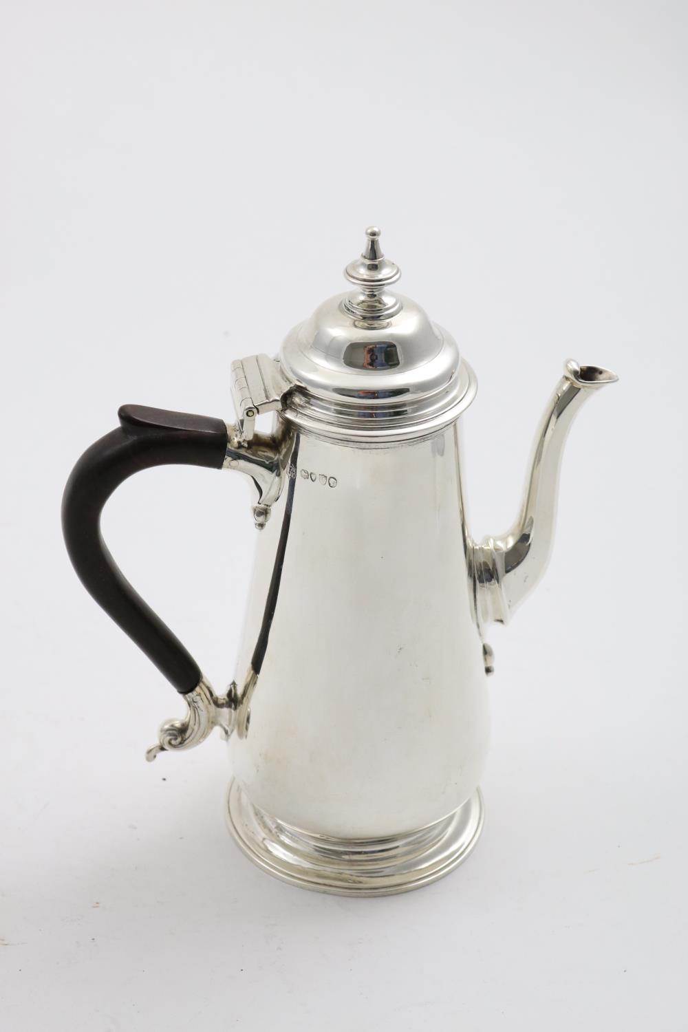 A LATE VICTORIAN COFFEE POT with a domed cover, knop finial, and a spreading circular foot, by T.
