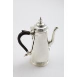 A LATE VICTORIAN COFFEE POT with a domed cover, knop finial, and a spreading circular foot, by T.