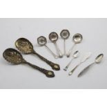 A PAIR OF LATE VICTORIAN SILVERGILT FRUIT SERVING SPOONS with cast stems and pierced bowls, by