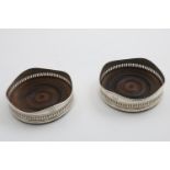 A MATCHED PAIR OF GEORGE III WINE COASTERS with pierced and engraved sides and wavy rims, turned