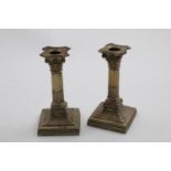 A PAIR OF EDWARDIAN DWARF CANDLESTICKS with fluted columns, decorated square bases and bead borders,