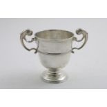 A RARE GEORGE II IRISH PROVINCIAL CUP of campana form with twin, harp-shaped handles, a reeded