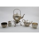 A VICTORIAN THREE-PIECE TEA SET with chasing and repousse-work decoration and the signs of the